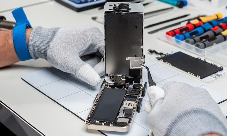 Phone repair workshop with technicians working on devices